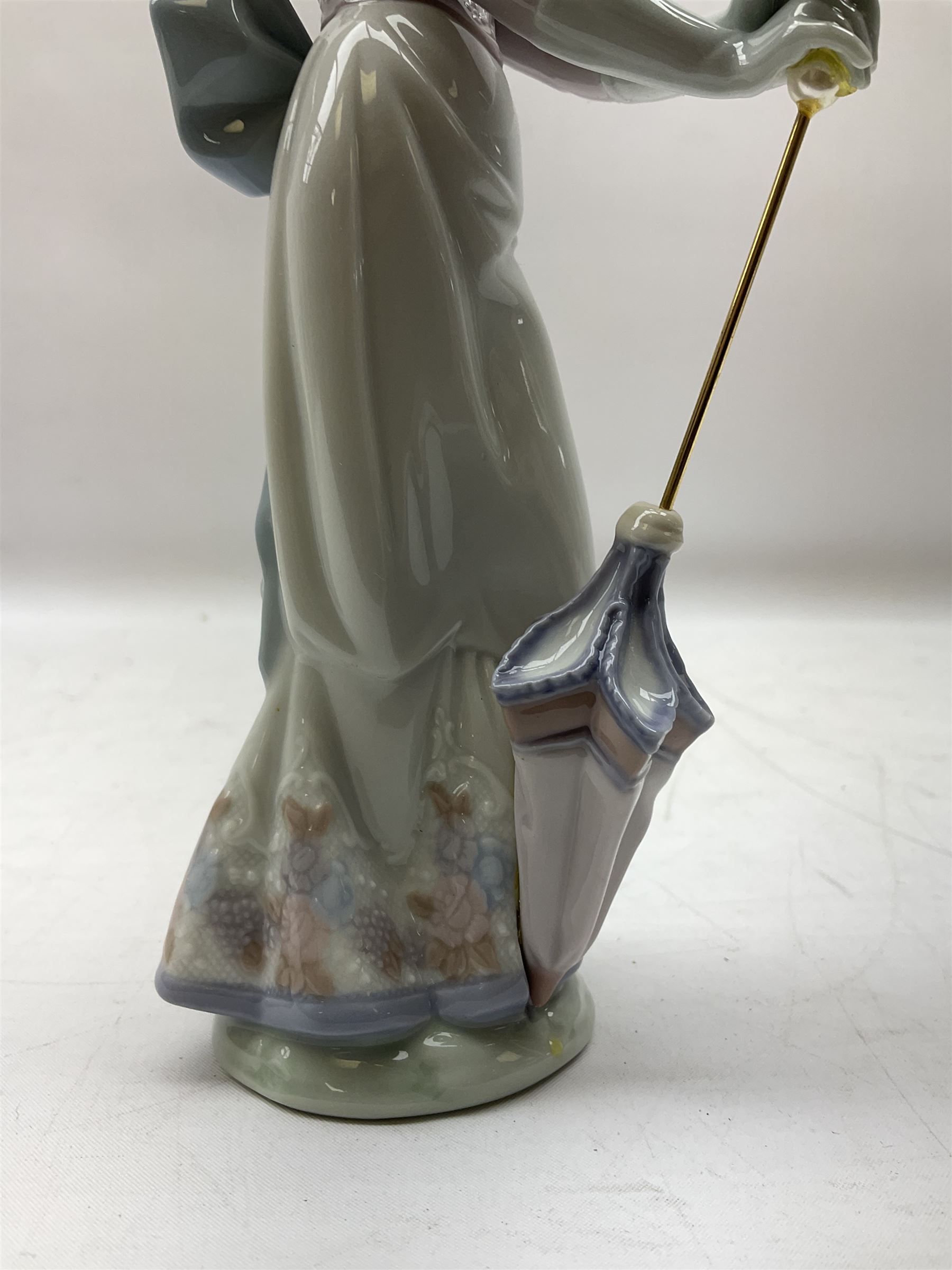 Two Lladro figures, comprising Garden Classic, no 7617 and Garden Song, no 7618, with original boxes and artists signature beneath, largest example H23cm