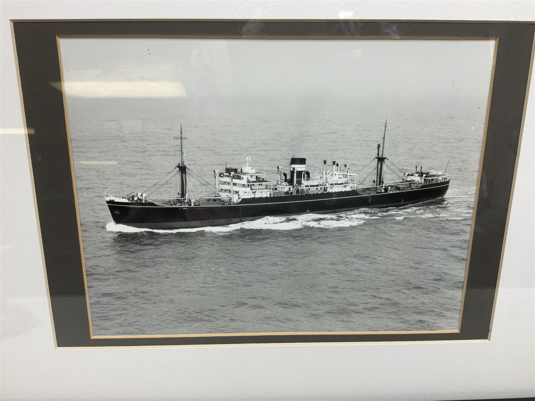 Set of twelve monochrome photographs of mid-20th century merchant vessels comprising general cargo ships, cargo liners, RMMV passenger cargo liners and hospital ship including Rowallan Castle, Drakensberg Castle, Stirling Castle, Capetown Castle, Pachumba, Tilapa etc; average size 18 x 24cm; uniformly mounted in black frames (12)