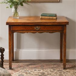 Georgian oak tea table, rectangular fold-over top above single frieze drawer with brass sw...