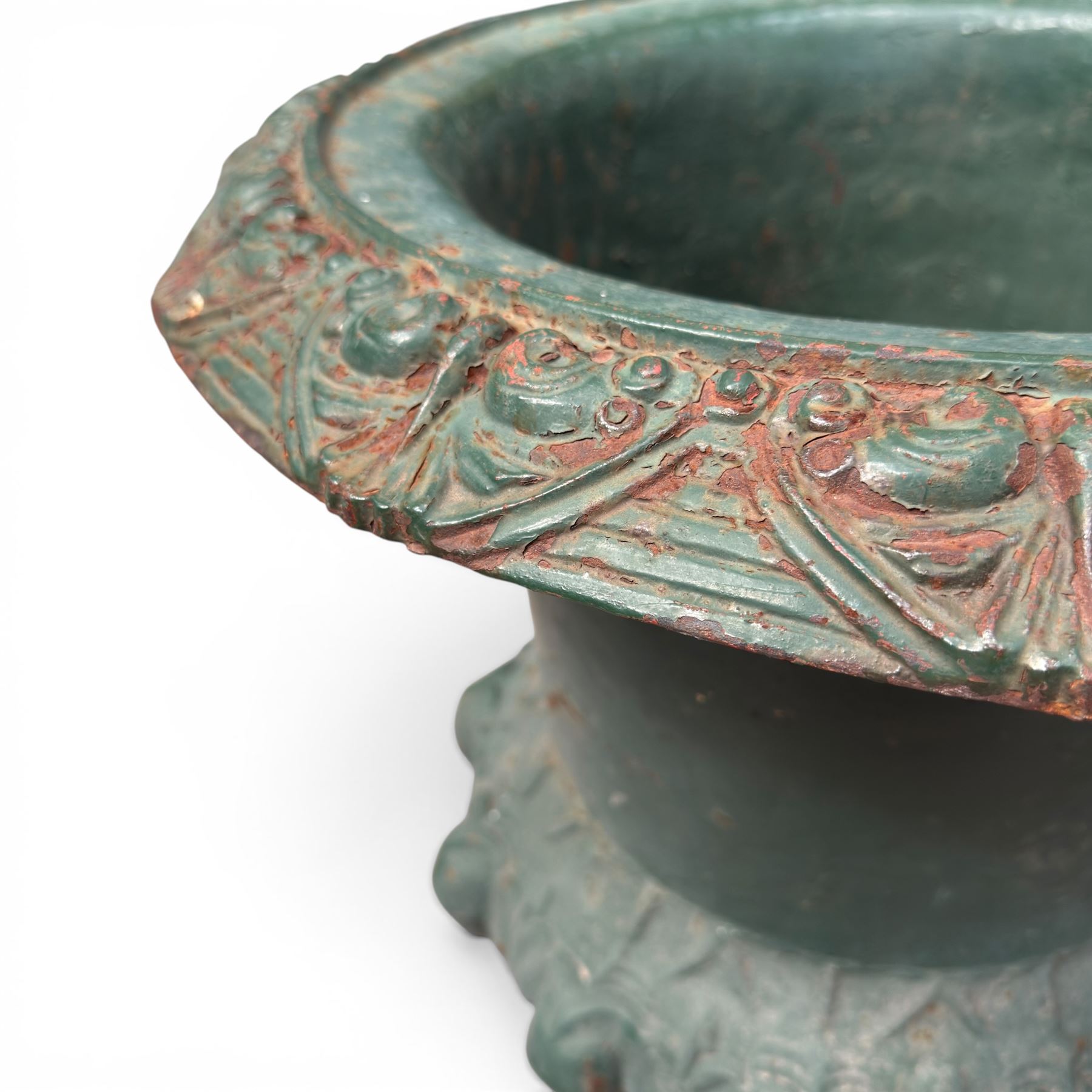 Pair of Victorian cast iron campana garden urns, the flared rim with repeating stylised anthemion motifs with scrollwork, over a deep gadrooned and Aesthetic moulded underbelly, fluted and foliate lower bowls on square pedestal bases, in antique green-painted finish