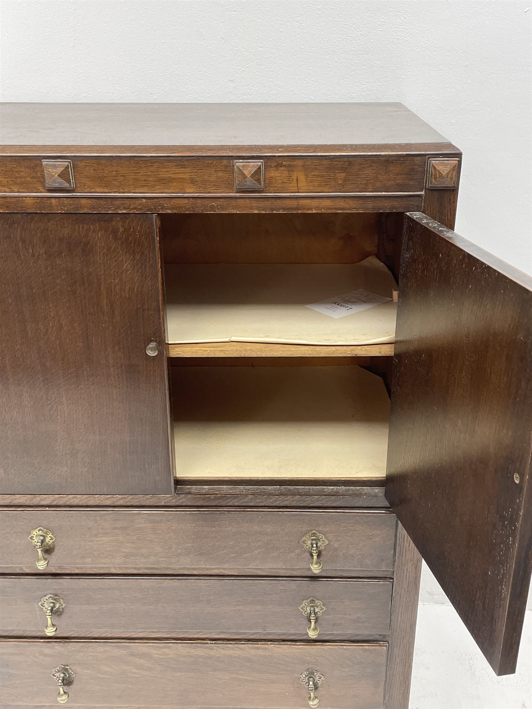 Early 20th century oak tallboy chest, double cupboard doors enclosing interior, above three long graduating drawers, raised on cabriole supports 