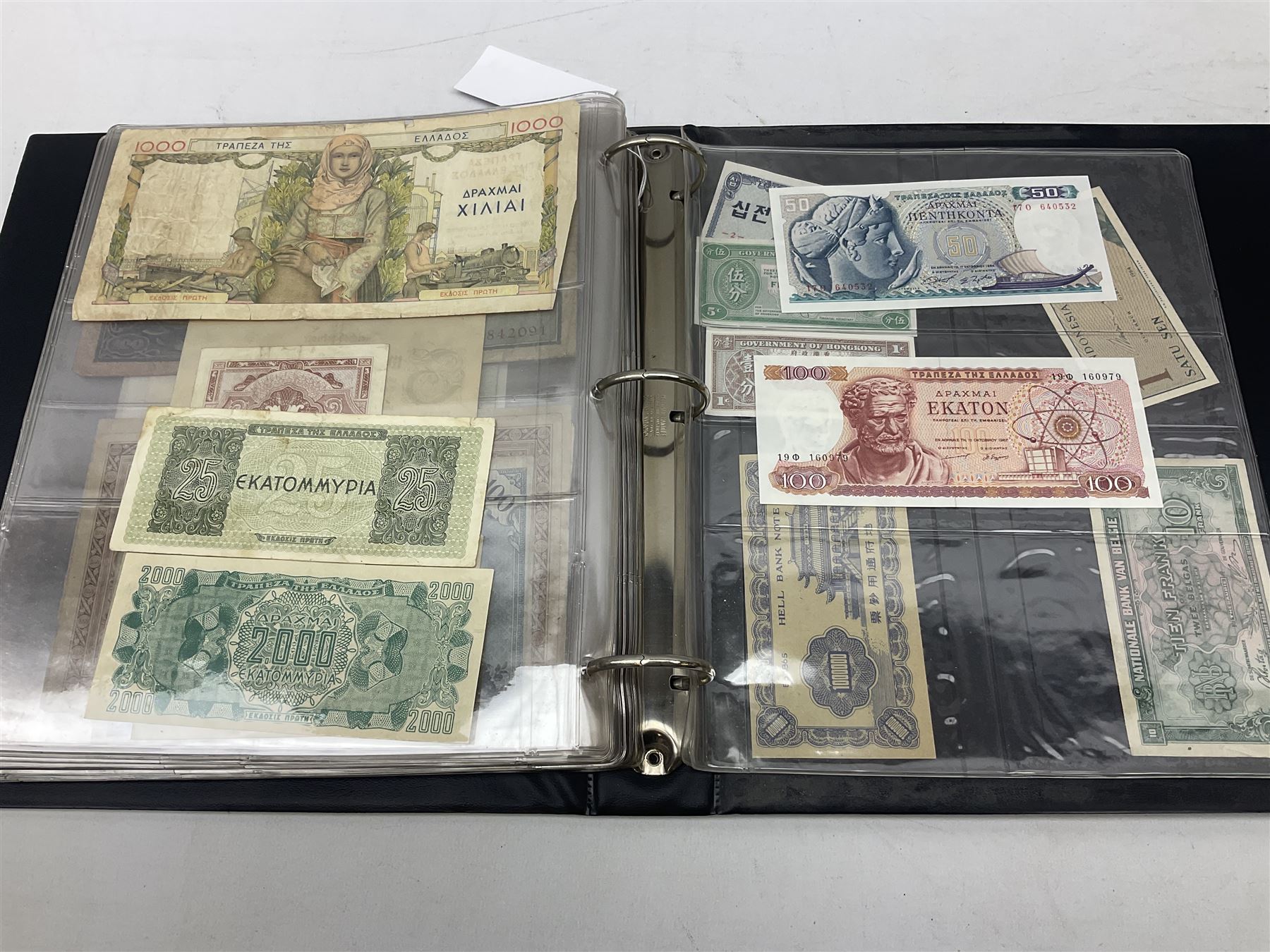 World banknotes, including Queen Elizabeth II The States of Jersey one pound 'DB202703', five pounds 'BB527762' and ten pounds 'AB651481', reserve bank of New Zealand two dollars '1L3 741894', King George V Straits Settlements one dollar 1st January 1935 'F/83 28924', various Bank of England notes etc, housed in two ring binder albums