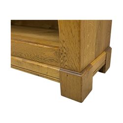 Contemporary French provincial design oak open bookcase, with projecting moulded cornice above a boarded back, fitted with four adjustable shelves, on bracketed plinth base