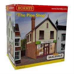 Ten Hornby '00' gauge Skaledale buildings, comprising R9834 Village Tea Rooms, R8506 Brambles Cottage, R8507 Platt's General Store, R8503 St Michaels School, R9769 The Pine Shop, R8641 Platform Footbridge, R8639 Water Tower, R8587 Coal Stage, R8589 Level Crossing Signal Box and R8638 Platform Shelter, all boxed