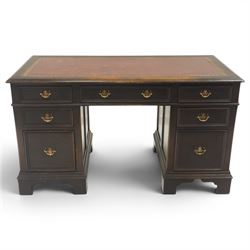 Titchmarsh & Goodwin style desk, rectangular top with inset red leather writing surface, central frieze drawer flanked by three drawers, pedestals fixed to the top, raised on bracket feet 