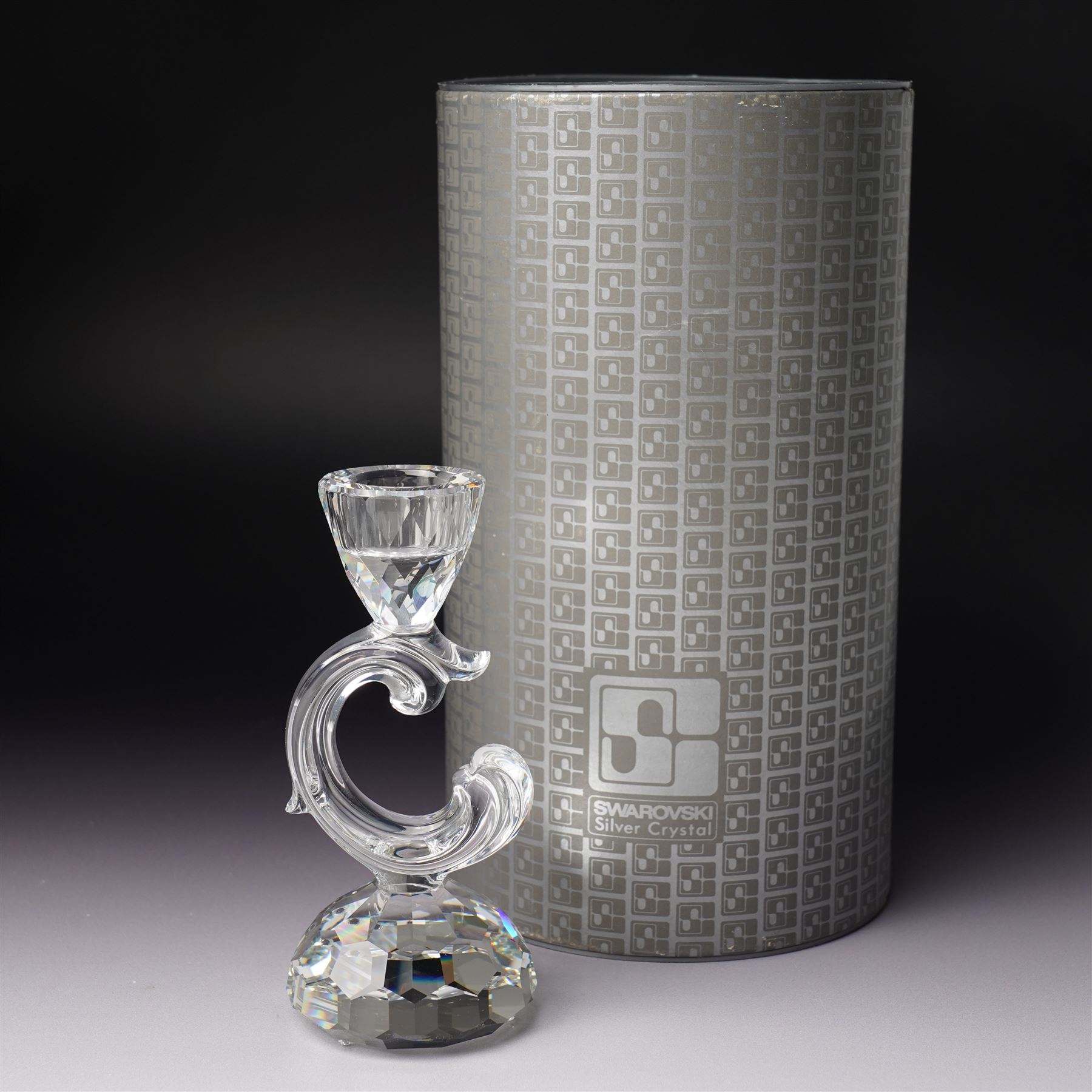 Pair of Swarovski Crystal candlesticks, boxed, together with two paperweights in the form of pineapples with gilt mounts, a large and small example, boxed (4)