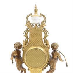 Italian- 20th century 8-day gilt figural mantle clock in the style of a 19th century Parisian lyre clock, drum movement with a porcelain dial flanked by playful cloven-hoofed cherubs on a white marble plinth, raised on a a decorative base with splayed paw feet, twin train spring driven Hermle movement with a floating balance escapement, sounding the hours and half hours on two bells. With key.    