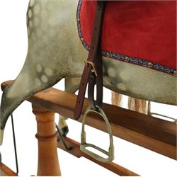 Frederick Henry Ayres (F H Ayres, London) - Late Victorian large carved wooden rocking horse, in dapple grey paint finish, decorated with glass eyes, leather reins, stirrup and saddle, indented hooves, on rockers united by chamfered stretchers and boarded base, c.1890