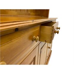 Polished pine farmhouse dresser, fitted with three drawers and three cupboards, with plate rack 