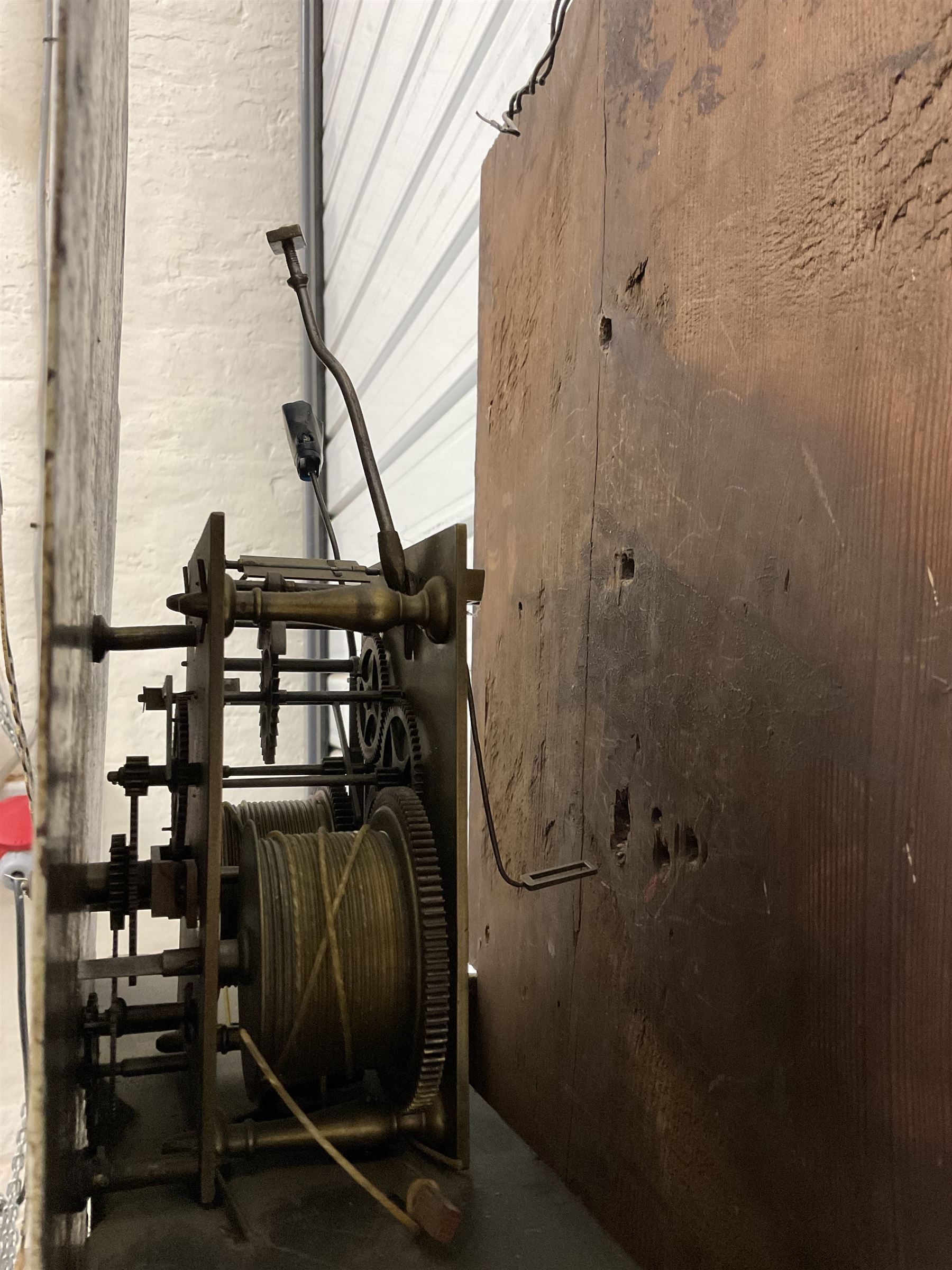 Late 18th century oak 8-day longcase clock, with a swan necked pediment and brass paterie, 
break arch hood door flanked by detached reeded pilasters, trunk with recessed quarter pillars and a long flat topped door, on a square plinth with canted corners, early painted dial with Arabic numerals and floral decoration to the arch and spandrels, with stamped brass hands and date recorder, weight driven two train movement with baluster movement pillars and an internal countwheel strike (bell missing). With pendulum and weights.  No makers name.