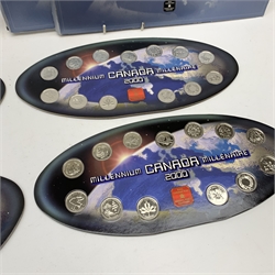 Four 'Canada Millennium 2000' coin sets, each consisting of thirteen commemorative twenty five cent coins on a card display