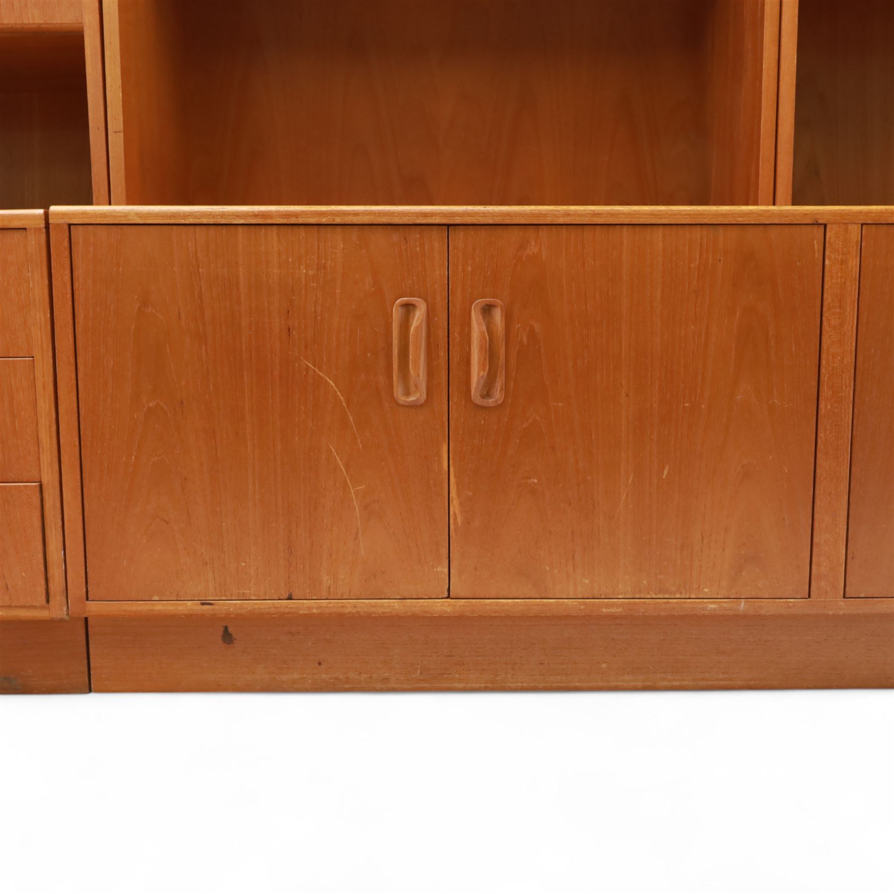 G Plan - Mid 20th century teak sectional wall cabinet, comprising six modular units including a fall front bureau, glazed display cabinet, open bookcase, cupboard and drawer bases, each with recessed handles and flush plinths