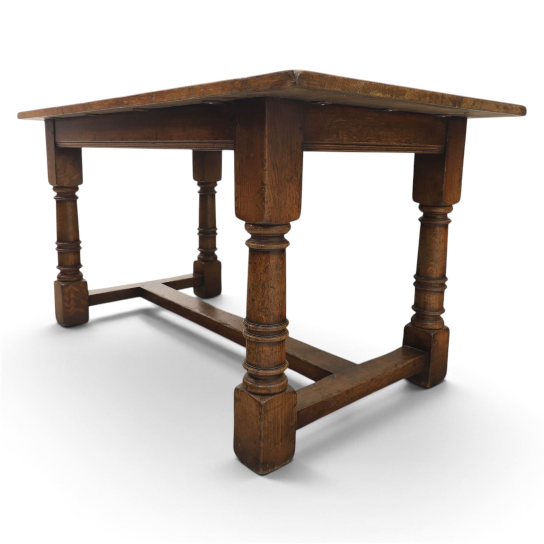 Titchmarsh & Goodwin style solid oak refectory table, rectangular top raised on block and turned supports united by a full length undertier
