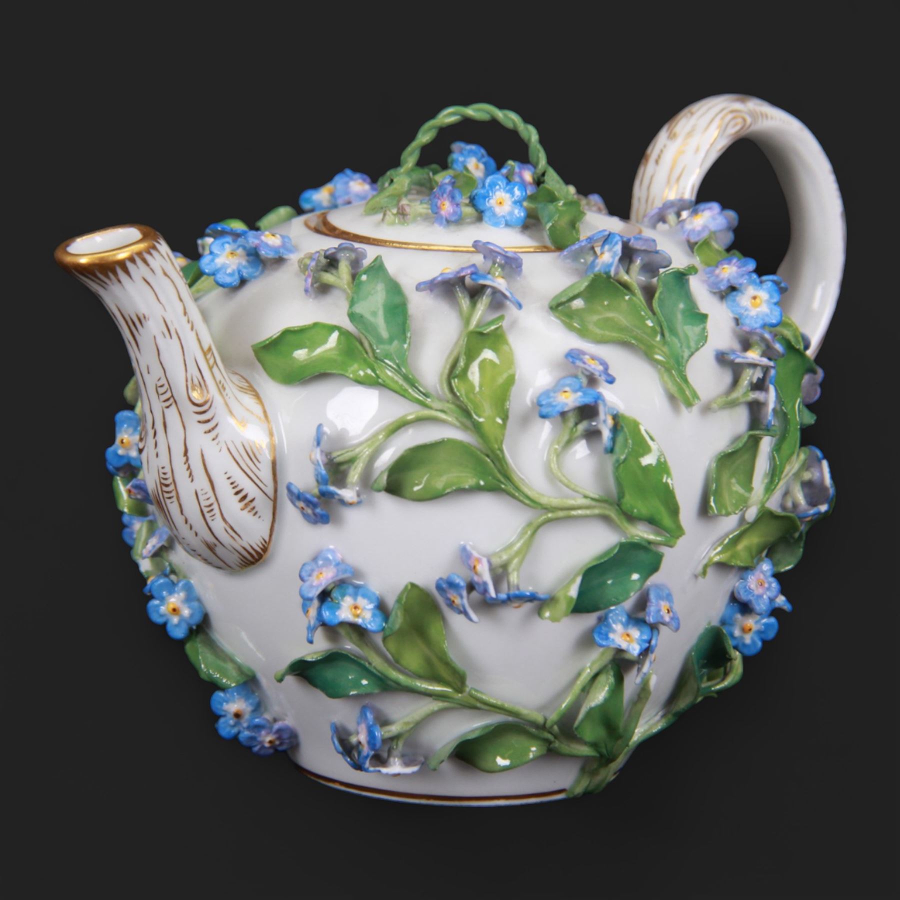 Late 19th century Meissen teapot, of ovoid form with gilt detailed 'crabstock' effect handle and spout, the body encrusted with forget-me-not flowers and leaves and painted with a single moth, with underglaze blue crossed swords mark beneath, H10cm