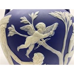 19th century Wedgwood dark blue dipped Jasperware Portland vase, of ovoid form with twin handles to shoulders and waisted neck, and flared rim, the body decorated with a continuous scene of classical figures in relief, the base decorated with portrait in relief, H26cm