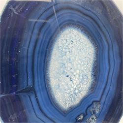 Pair of blue agate slices, polished with rough edges, raised upon silvered metal stands, H26cm