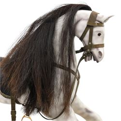 Late 20th century polychrome painted rocking horse, modelled in dapple grey finish with horse hair mane and tail, leather tack and saddle, stirrups, raised on a pine trestle base