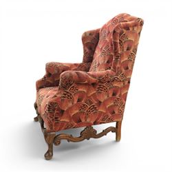 Large upholstered wingback chair, crimson geometric upholstery, carved front apron raised on cabriole supports 