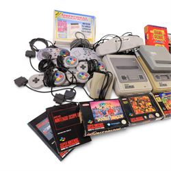 Two Super Nintendo Entertainment System consoles, accessories to include Super Multitap, UFO Super Drive Pro, Universal Adapter, Game Genie, Scope 6 accessories (Scope not present), seven controllers including one Competition Pro and a SN Pro Pad and fifteen SNES games comprising eleven boxed and four unboxed examples, titles to include Dragon The Bruce Lee Story, Street Fighter II Turbo x2 (one unboxed), Royal Rumble, Super Mario Kart, Radical Psycho Machine Racing, Super Bomberman, Super Bomberman 2, Protector Alien Rebels, Double Dragon, Goof Troop, WWE Raw Wrestling, Tetris Attack, Donkey Kong Country and Starwing
