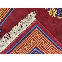 Tibetan-design handwoven rug, deep red field with three central medallions in yellow and blue, traditional yellow key border, white fringes on both ends