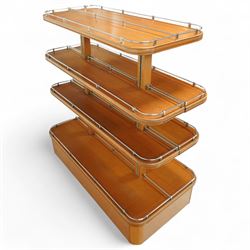 Mid-20th century retail display stand, of stepped rectangular tiered form with four graduated adjustable shelves, each with rounded corners and fitted with tubular chrome safety rails, supported by central chrome-mounted wooden uprights over a plinth base