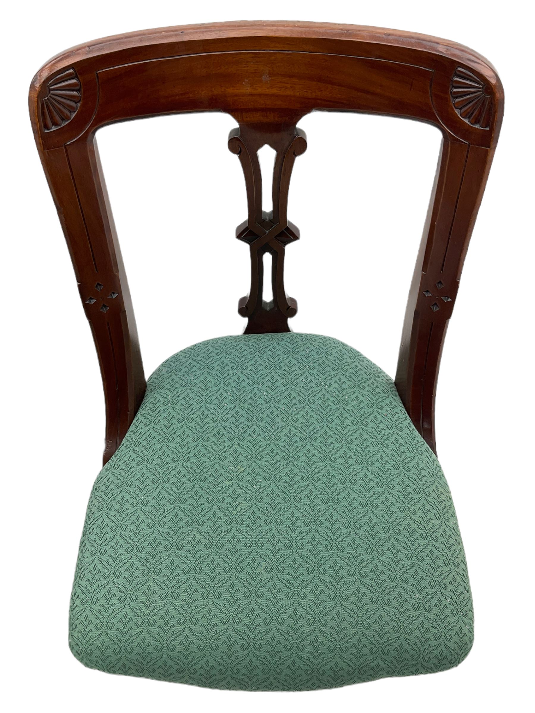 Set of four Victorian mahogany spoon back dining chairs, upholstered seats