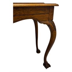 Late 19th century oak display cabinet, rectangular form with a pair of glazed doors enclosing shelves, raised on cabriole supports with carved detailing ending in claw feet