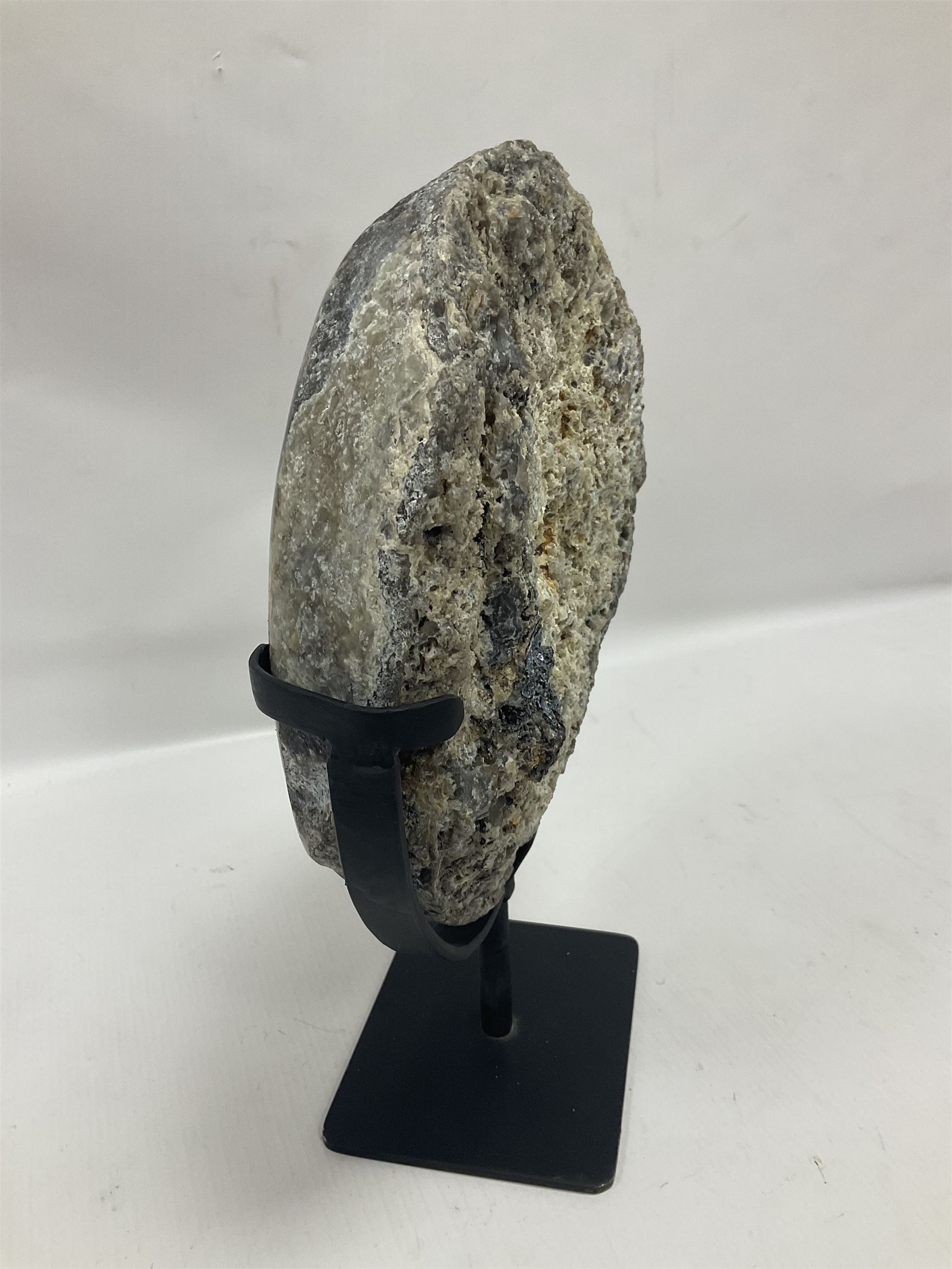 Large agate geode with quartz crystals to the centre, upon a metal stand, H35cm 