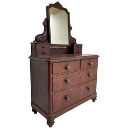 Victorian scumbled pine dressing chest, raised swing mirror in moulded frame with scrolled carved pediment, foliage S-scroll carved supports over trinket drawers, moulded rectangular top with rounded corners over two short and two long drawers, skirted base on turned feet, scumbled to resemble mahogany 