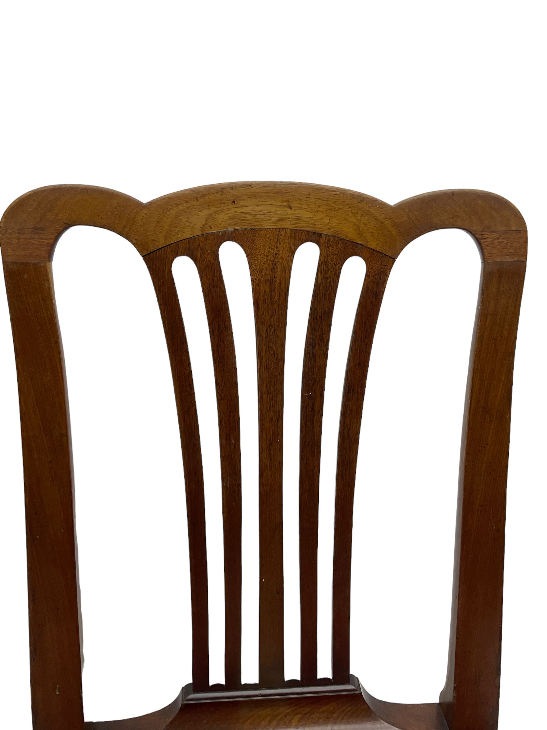 Set of six (5+1) George III mahogany dining chairs, shaped cresting rail over pierced and flared splat, drop-in seat upholstered in crimson and ivory floral patterned fabric, raised on chamfered square supports united by H-stretcher