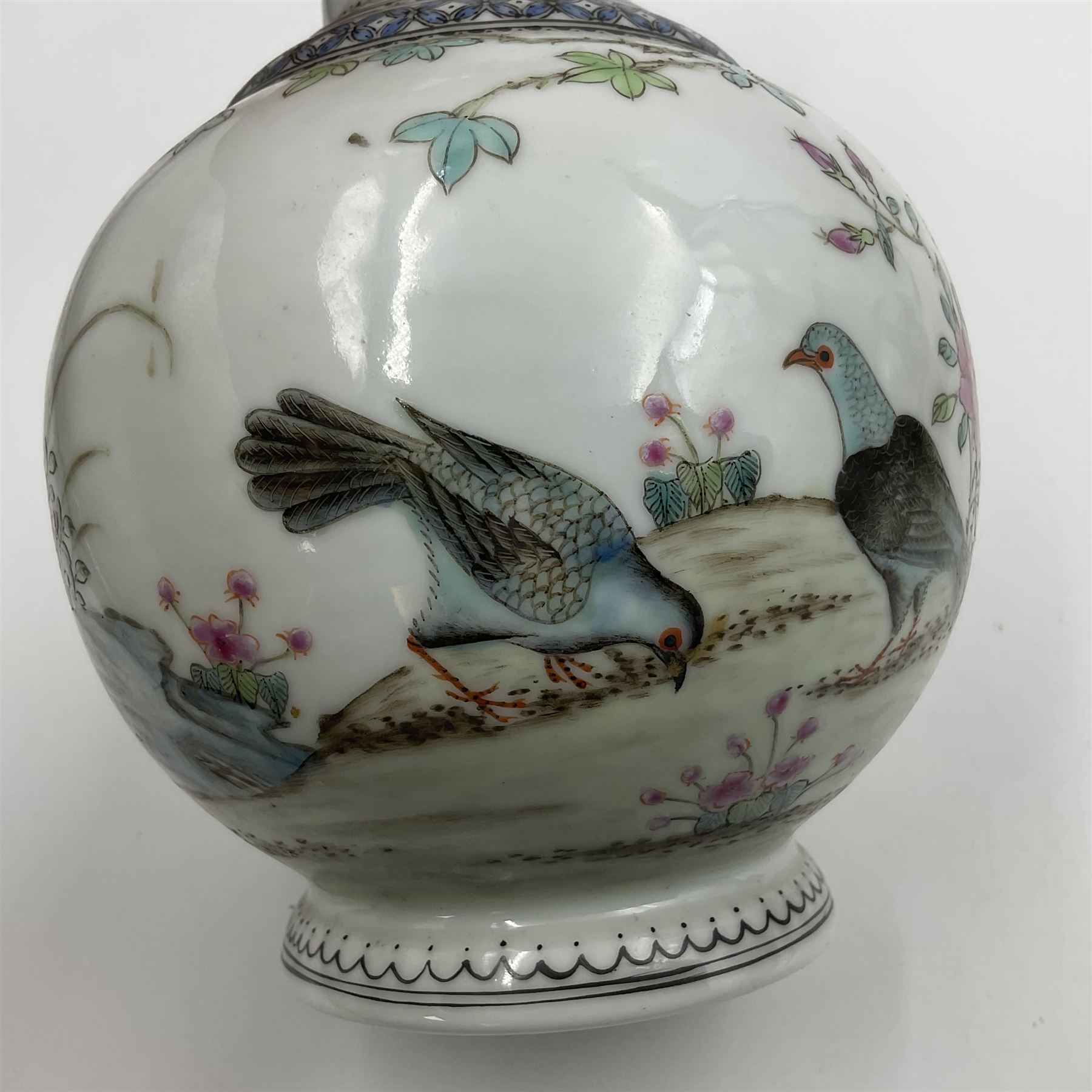 Pair of Chinese Republic porcelain vases, each painted in Famille Rose enamels with pairs of pigeons amidst peony, rock, flowering plants and leafy branches, possibly Qianlong seal beneath, H22cm 