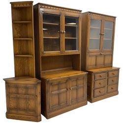 Ercol - mid-20th century dark elm 'Old Colonial' three sectional wall display unit, comprising two units and corner unit, fitted with open shelves, glazed cupboards and drawers