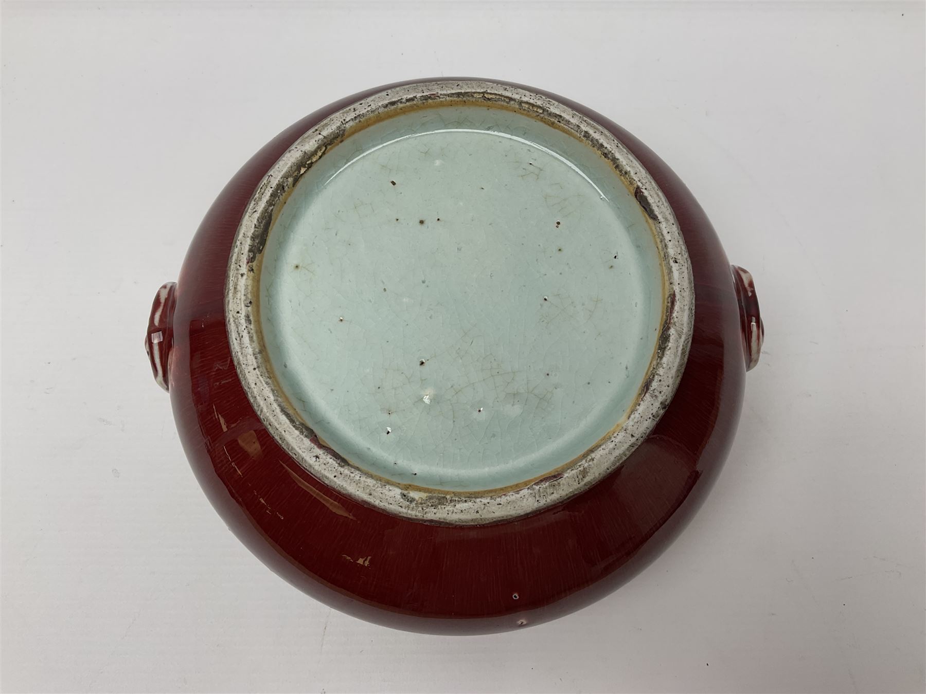 Qing Chinese Sang De Boeuf incense burner, Qing Dynasty, of bombe form with applied lion-mask handles, H11cm