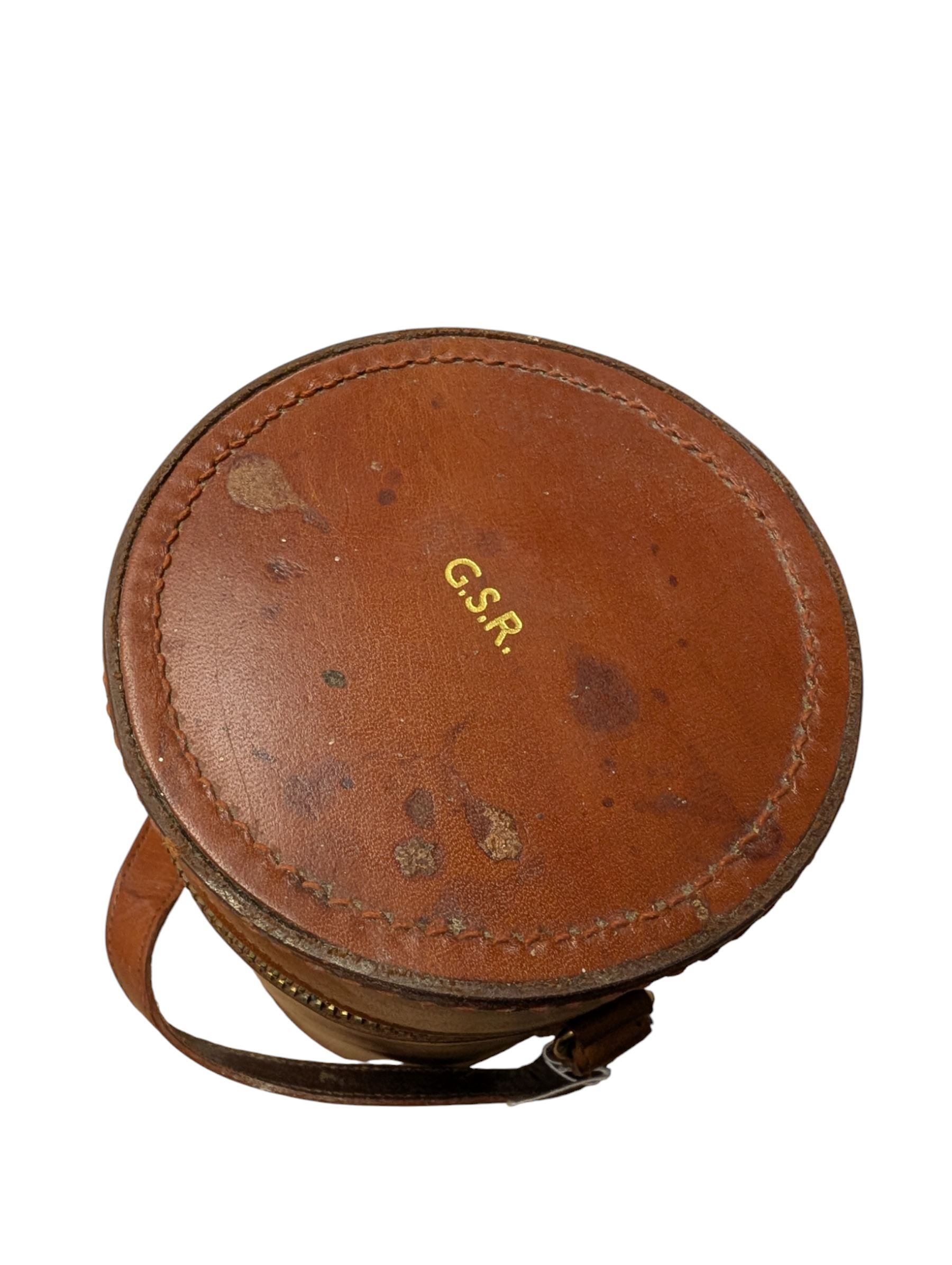 Set of three curved glass flasks with EPNS collars and lids, contained within a hide case with gilt initials