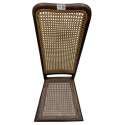 Early 19th century stained beech and mahogany child's correction chair, cane seat and back raised on turned supports united by stretchers