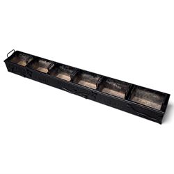 Black-painted iron herb planter, the long rectangular body embossed ‘Thyme, Basil, Oregano, Parsley, Mint’ with applied foliate decoration, containing five removable handled liners
