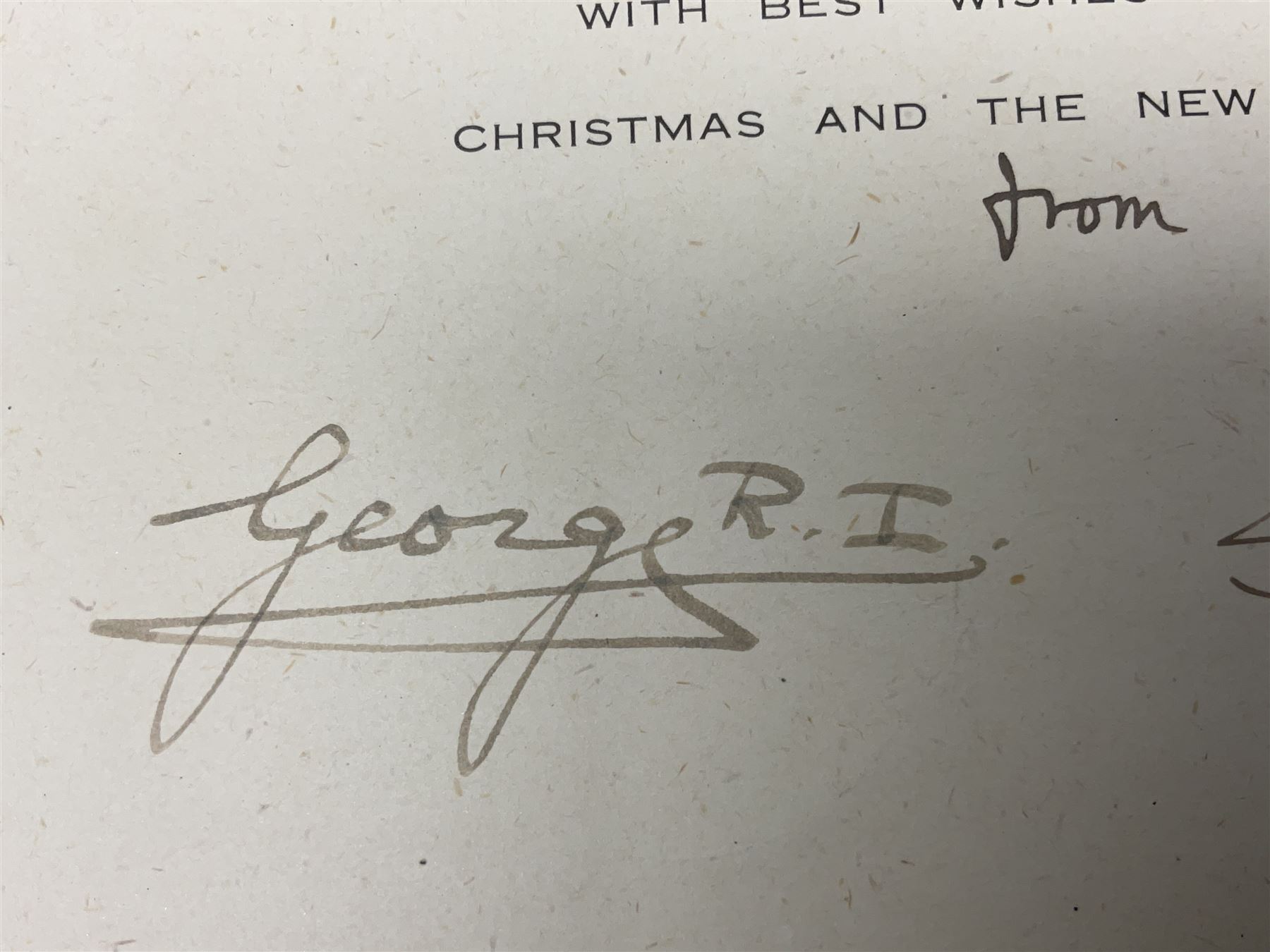 King George VI and Queen Elizabeth - signed 1945 Christmas card with gilt embossed crown to cover, black and white photograph to the interior, of The Royal Family waving from the balcony of Buckingham Palace, on V-E Day Tuesday May 8th 1945, signed 'George R.I. Elizabeth R.'
