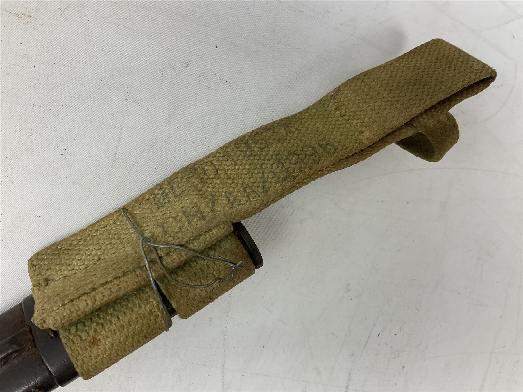 British Pattern 1907 bayonet with 43.5cm fullered steel blade; in leather scabbard with webbing frog L58cm overall; another Pattern 1907 bayonet lacking scabbard; and British Pattern 1888 Mk.I bayonet by Wilkinson London (no scabbard) (3)