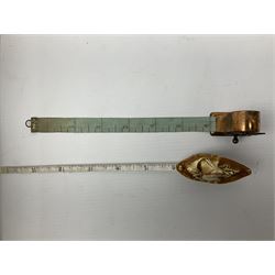 Copper tape measure in the form of a ship`s wheel, marked 'Rd. 128885' to the front, and a celluloid tape measure in the form of a galleon, wheel H4cm