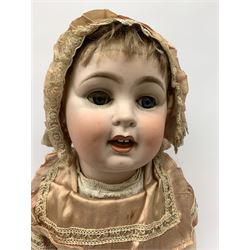 German bisque head doll with applied hair, sleeping eyes and open mouth with teeth and fixed tongue, on composition body with jointed limbs, marked 'P.M. 914 Germany 14' H65cm