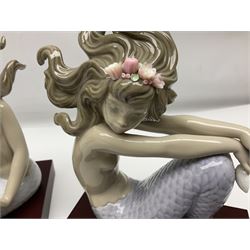 Lladro Mermaid trio set, comprising Illusion no. 1413, Fantasy no.1414 and Mirage no. 1415, all with wooden bases, largest H20cm