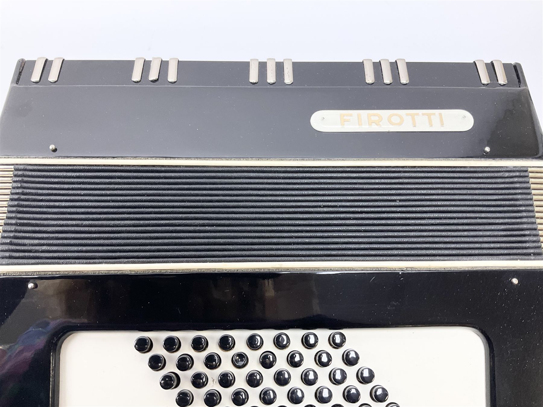 GDR Firotti piano accordion with black and silver case, sixteen keys and forty-eight buttons L38cm; in simulated reptile skin case with sheet music