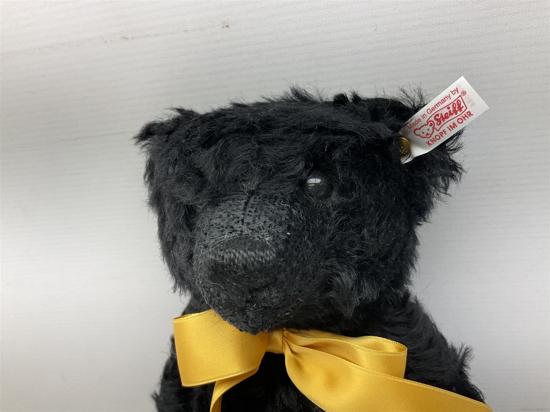 Steiff Special Edition Prince Charles black bear, with HRH coat of arms on foot and growler mechanism, with white tag ear label, in original box, together with Steiff 'Yorkshire Tyke' bear with rose on foot