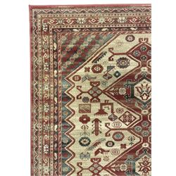 Persian design red ground rug, the field decorated with three interlinked lozenges and small stylised plant motifs, the multiple band border decorated with Boteh and floral motifs