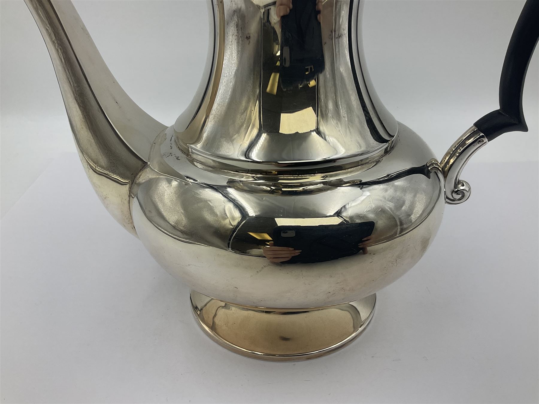 1920s five-piece silver tea service, comprising teapot, coffee pot, hot water pot, twin handled open sucrier and milk jug, each of squat circular form with shaped rim, the teapot, coffee pot and hot water pot each with ebonised handle and finial, the sucrier and milk jug with acanthus capped scroll handles, all upon circular foot, hallmarked R F Mosley & Co, Sheffield 1926 & 1927, tallest H24cm