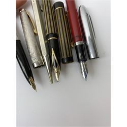Three Sheaffer fountain pens, comprising a Lady Sheaffer fountain pen with bark effect decoration to body and nib marked 14K, an example with black and gold coloured vertical reeded body and nib marked 585 14K, and an example with burgundy resin body, chrome cap and nib marked 305, together with a silver Yard-O-Led propelling pencil with engine turned decoration to body, hallmarked E Baker & Son, Birmingham 1975.
