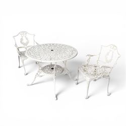 Victorian design cast aluminium garden table and twin armchairs featuring a pierced floral wreath splat, over a stylised scrolling acanthus leaf seat, including parasol