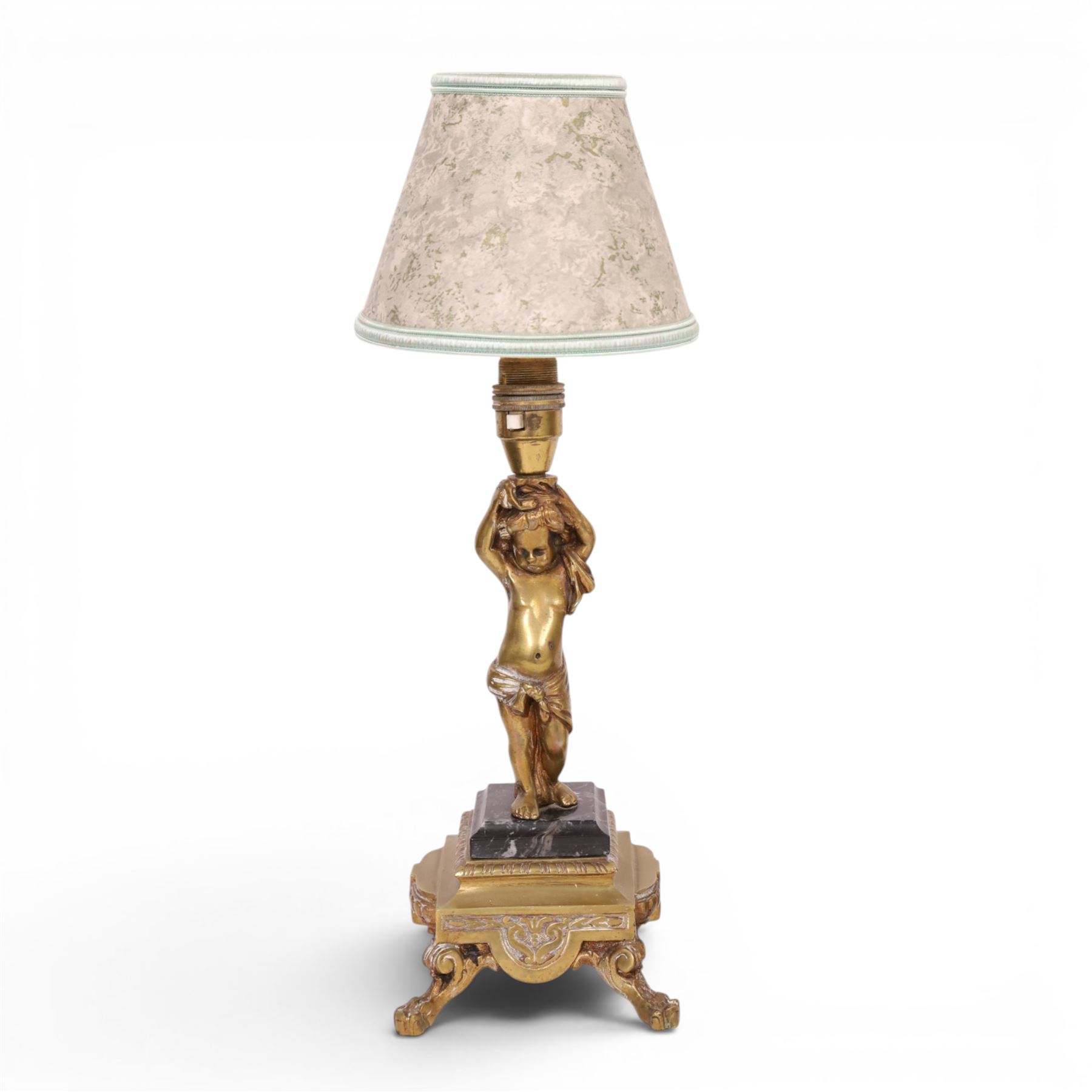 Pair of brass table lamps, the central column modeled as a putti upon a square marble base raised upon four claw feet, H29cm