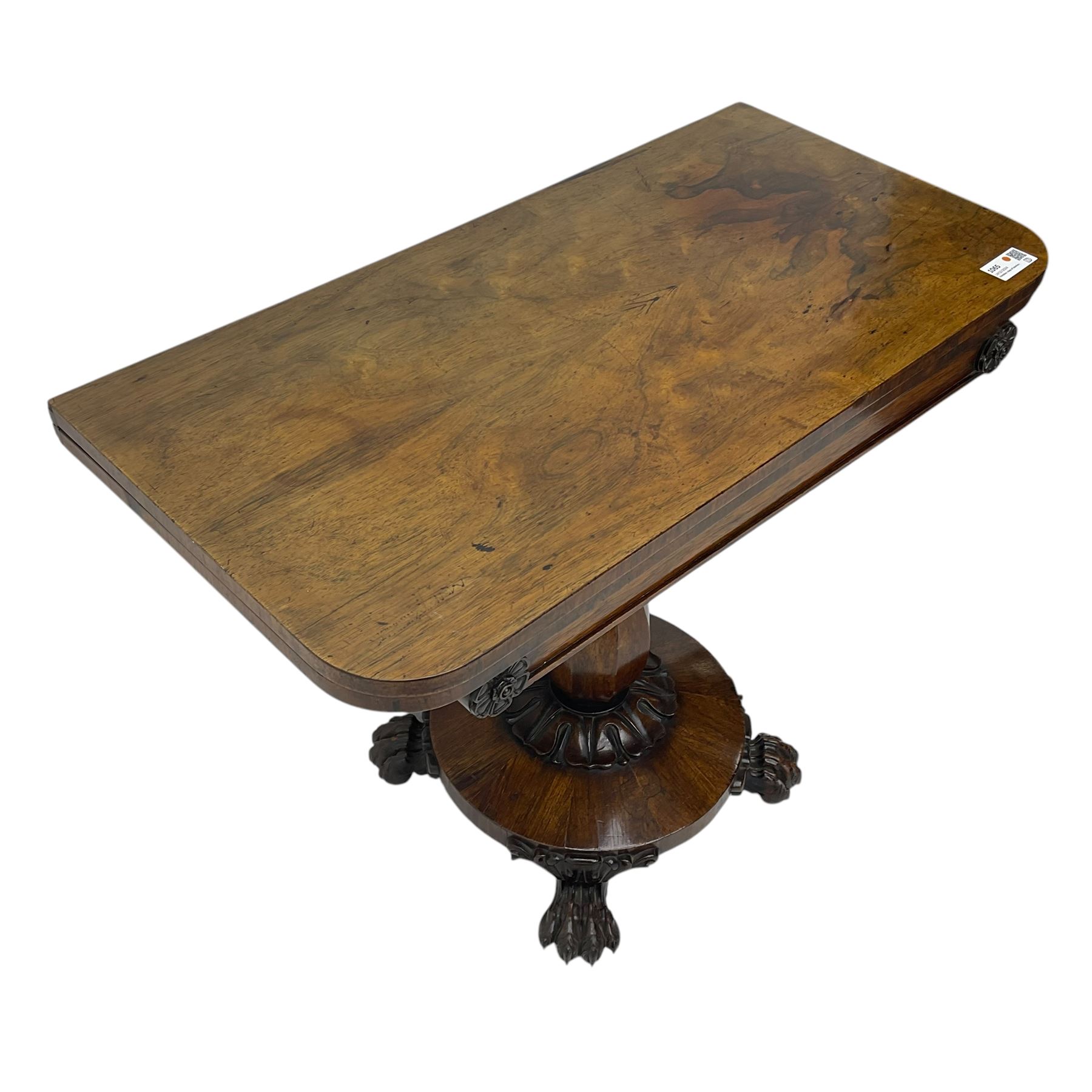 Victorian mahogany tea table, rectangular top with rounded corners, folding and swivelling to reveal interior surface, supported on a faceted baluster-shaped column, raised on a circular platform base with carved acanthus details, ending in four lion paw feet