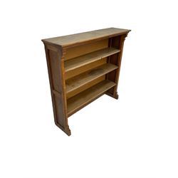 Early 20th century oak bookcase, fitted with four shelves, raised on sledge feet